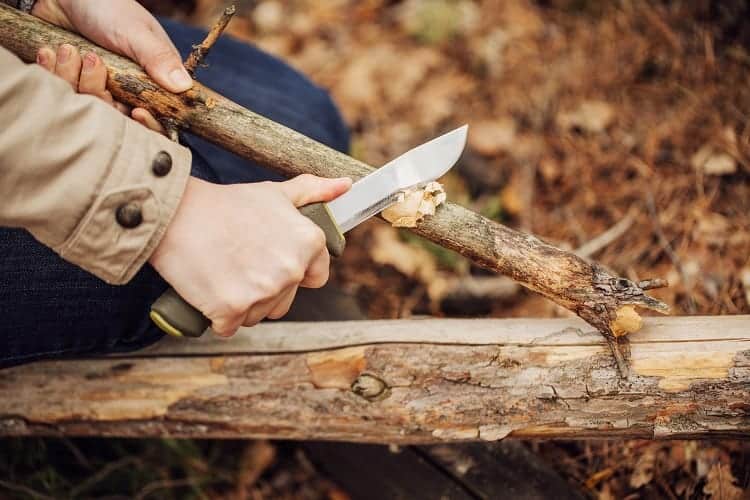 Using Outdoor Knife To Cut Wood